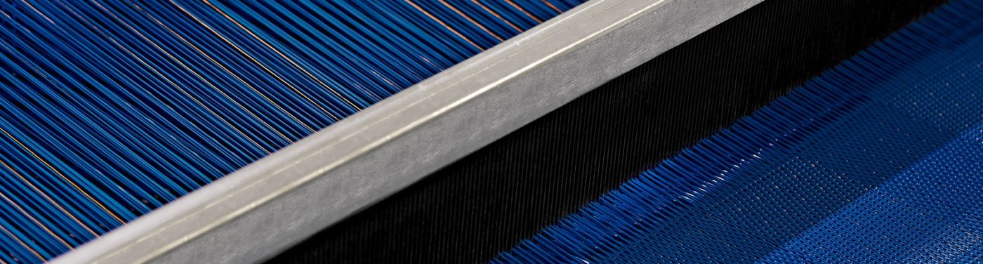 A close up of the edge of a weaving loom