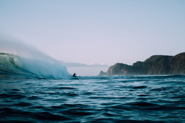 A person on a surfboard in the ocean.