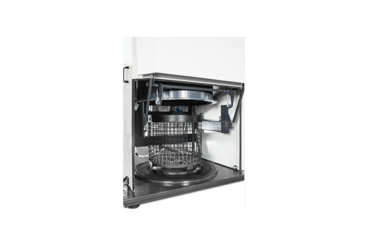 A microwave oven with the door open and its basket in it.